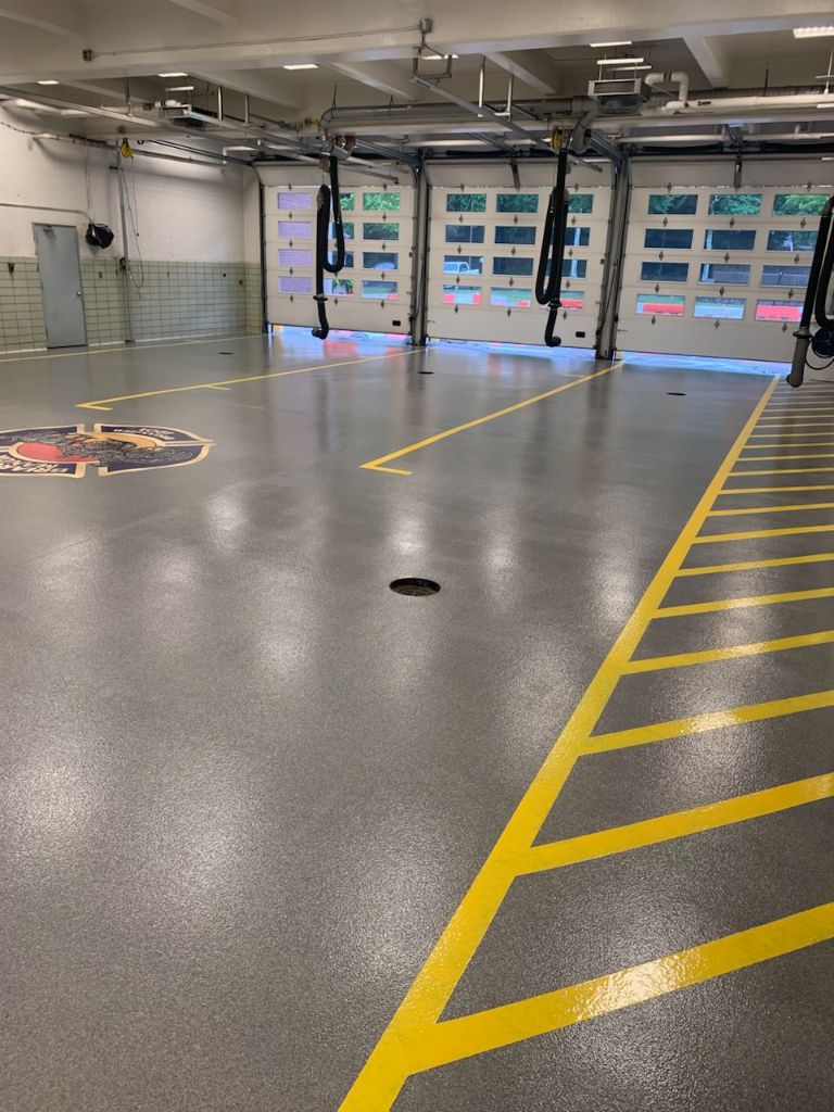 Fire station grey decorative quartz floor with lines and logo — Elmsford, NY