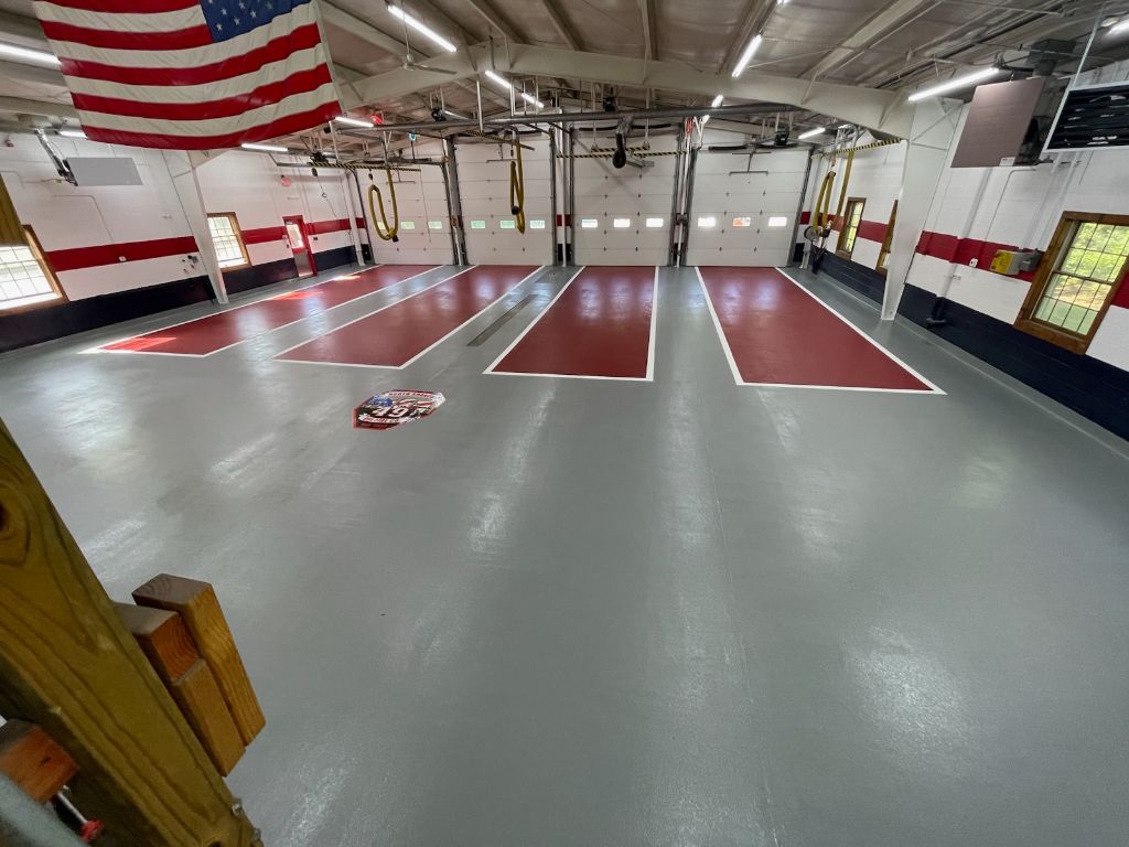 Fire station floor with pigmented urethane cement, lines and logo — Branchburg, NJ